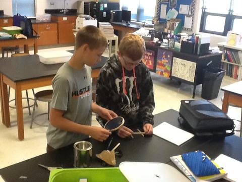 Two students doing an experiment